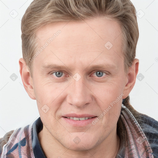 Joyful white adult male with short  brown hair and blue eyes