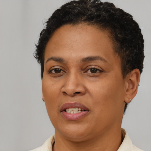 Joyful black adult female with short  brown hair and brown eyes