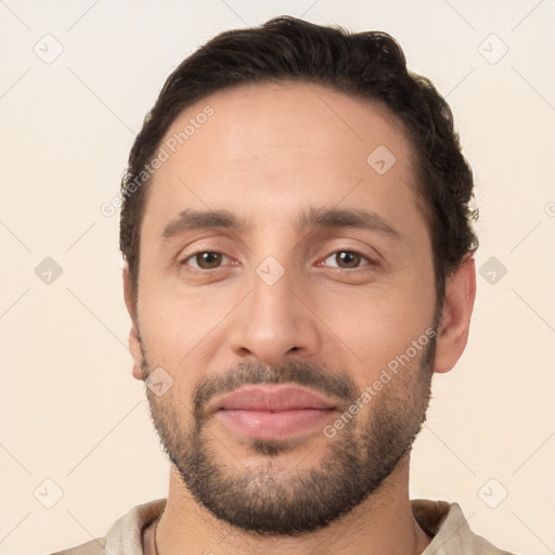 Joyful white young-adult male with short  brown hair and brown eyes