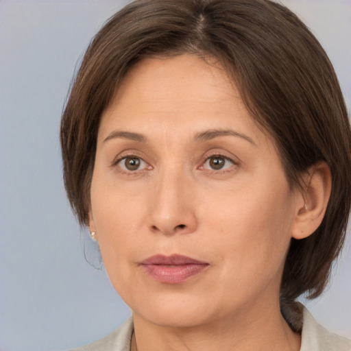 Joyful white adult female with medium  brown hair and brown eyes