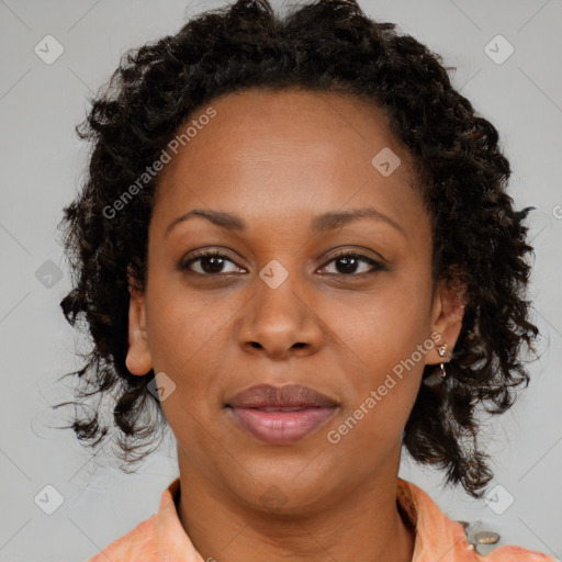 Joyful black adult female with medium  brown hair and brown eyes