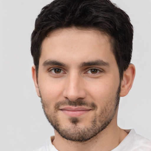 Joyful white young-adult male with short  black hair and brown eyes