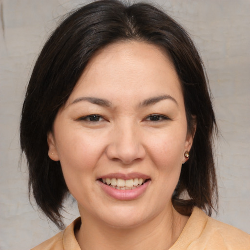 Joyful white young-adult female with medium  brown hair and brown eyes