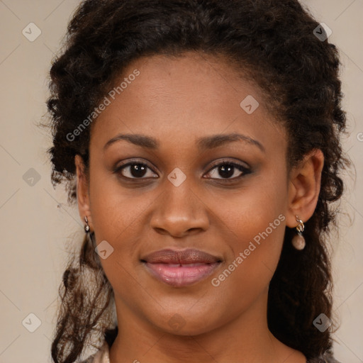 Joyful black young-adult female with long  brown hair and brown eyes