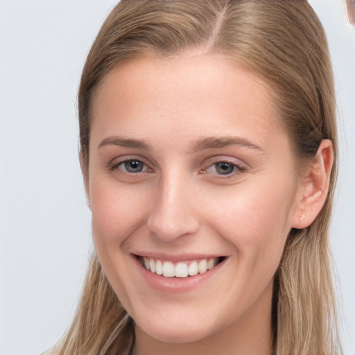 Joyful white young-adult female with long  brown hair and grey eyes