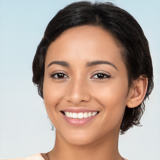 Joyful latino young-adult female with medium  black hair and brown eyes