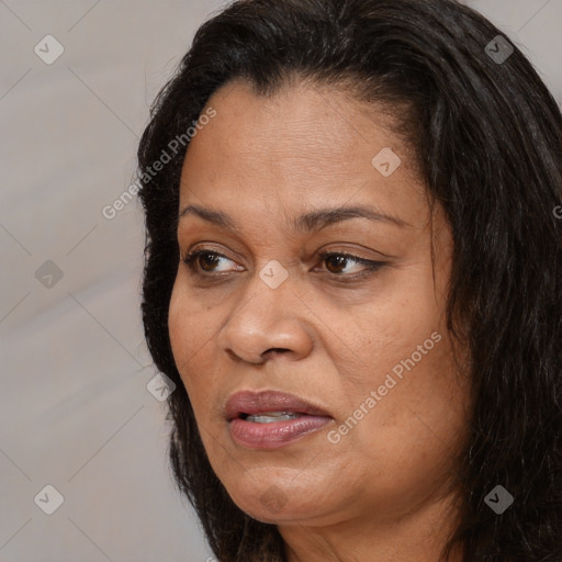 Joyful black adult female with long  brown hair and brown eyes