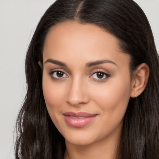 Joyful latino young-adult female with long  brown hair and brown eyes