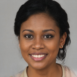 Joyful black young-adult female with medium  brown hair and brown eyes