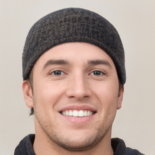 Joyful white young-adult male with short  black hair and brown eyes