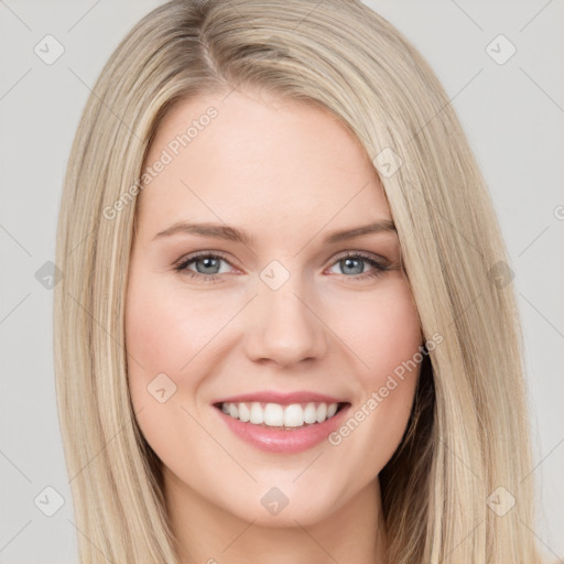 Joyful white young-adult female with long  brown hair and grey eyes