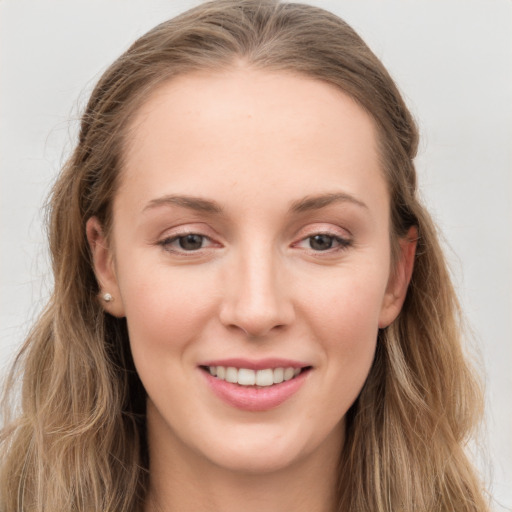 Joyful white young-adult female with long  brown hair and grey eyes