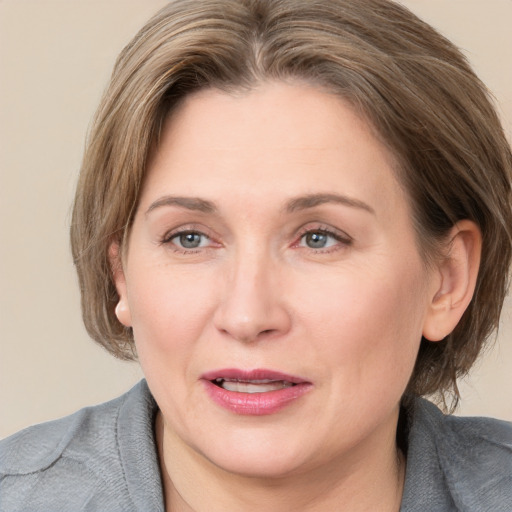 Joyful white adult female with medium  brown hair and brown eyes