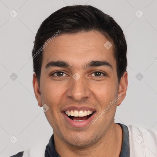 Joyful white young-adult male with short  black hair and brown eyes