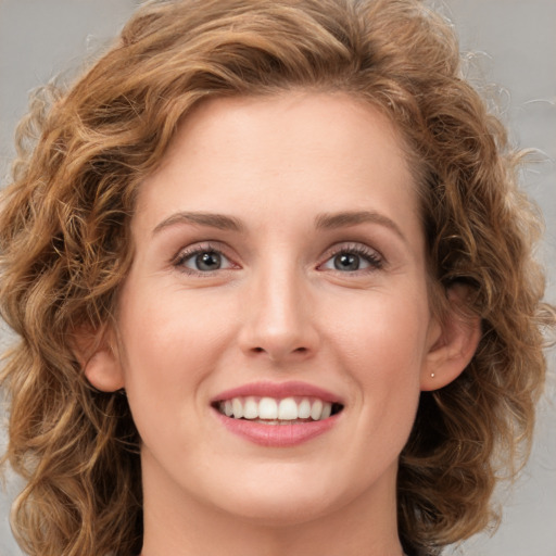 Joyful white young-adult female with long  brown hair and green eyes