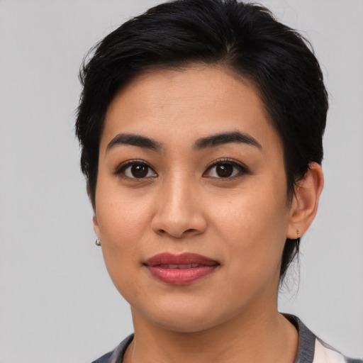 Joyful asian young-adult female with medium  black hair and brown eyes