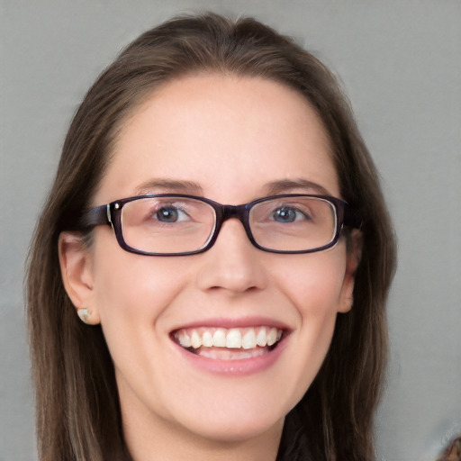 Joyful white young-adult female with long  brown hair and blue eyes