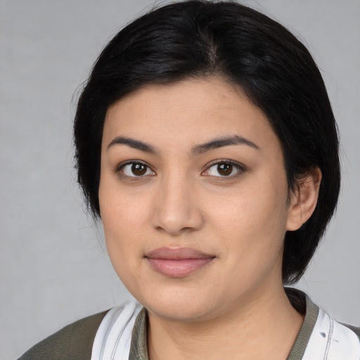 Joyful latino young-adult female with medium  black hair and brown eyes