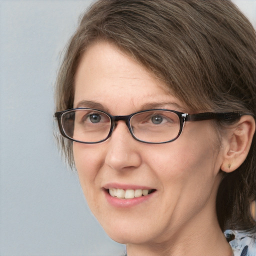 Joyful white adult female with medium  brown hair and blue eyes