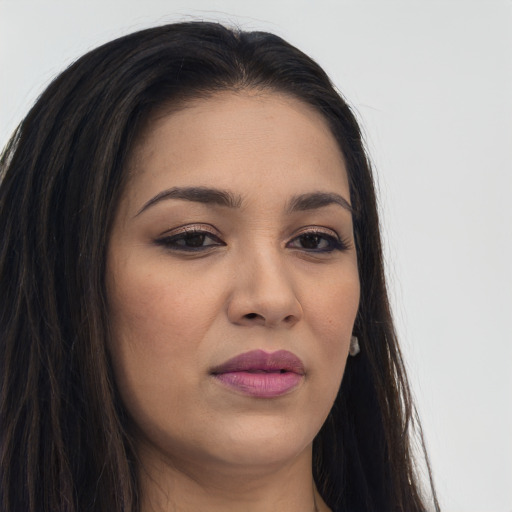 Joyful latino young-adult female with long  brown hair and brown eyes