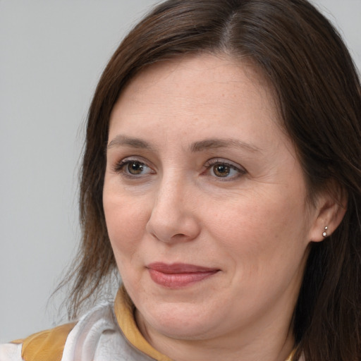 Joyful white adult female with medium  brown hair and brown eyes