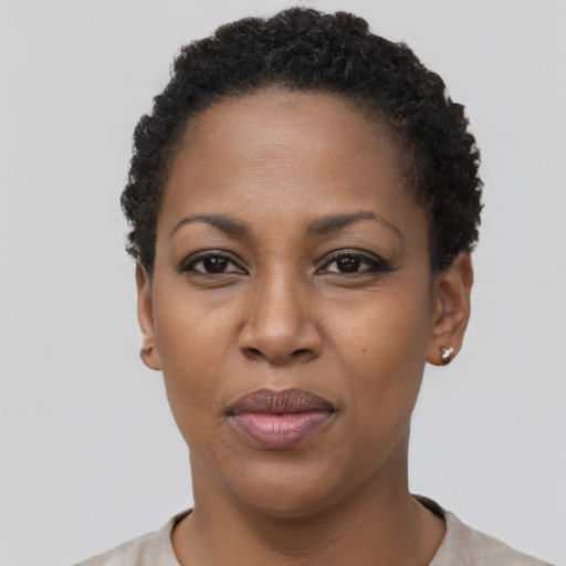 Joyful black adult female with short  black hair and brown eyes