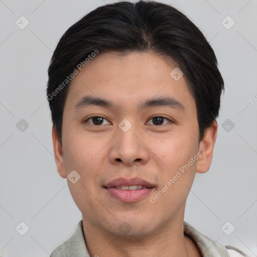 Joyful asian young-adult male with short  brown hair and brown eyes