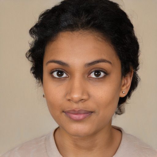 Joyful black young-adult female with medium  black hair and brown eyes