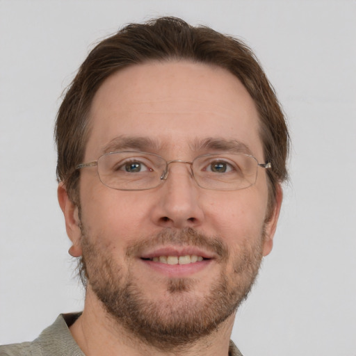 Joyful white adult male with short  brown hair and green eyes