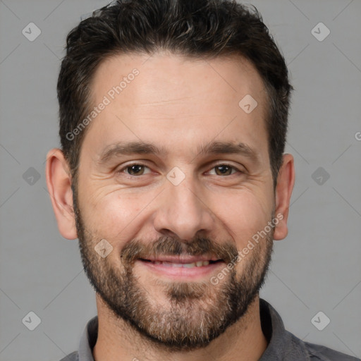 Joyful white adult male with short  brown hair and brown eyes