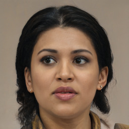 Joyful latino young-adult female with medium  brown hair and brown eyes