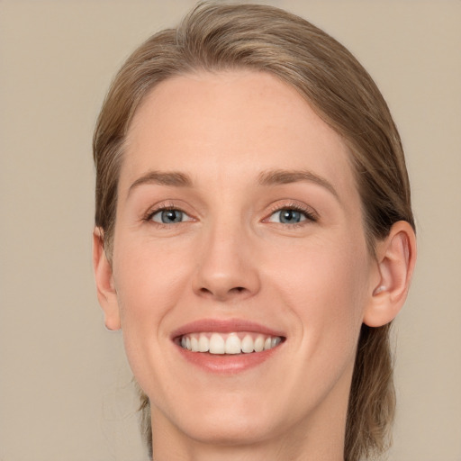 Joyful white young-adult female with long  brown hair and blue eyes