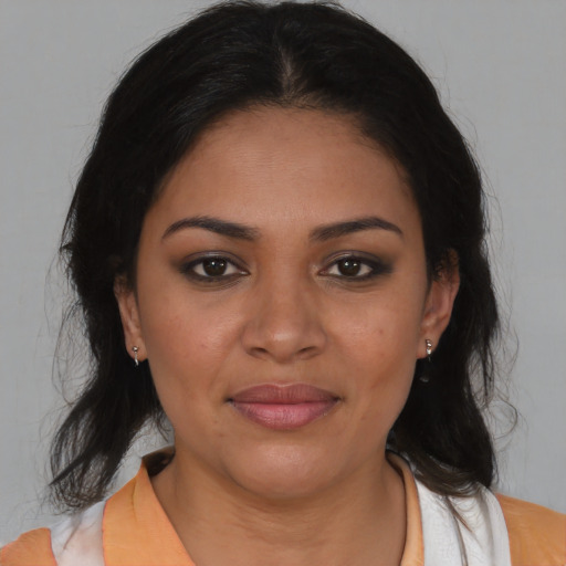Joyful latino young-adult female with medium  brown hair and brown eyes