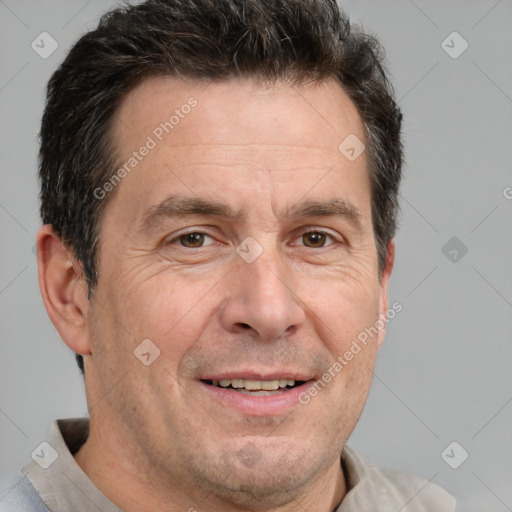 Joyful white adult male with short  brown hair and brown eyes