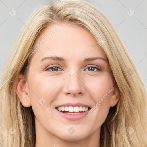 Joyful white young-adult female with long  brown hair and blue eyes