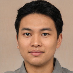 Joyful asian young-adult male with short  black hair and brown eyes