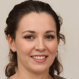 Joyful white young-adult female with medium  brown hair and brown eyes