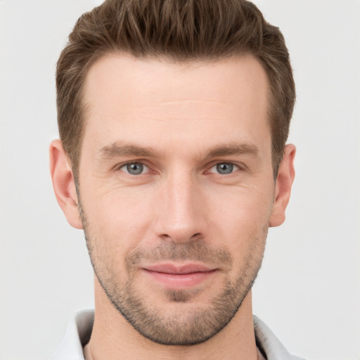 Joyful white young-adult male with short  brown hair and grey eyes