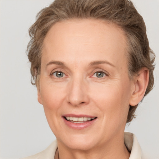 Joyful white adult female with medium  brown hair and grey eyes