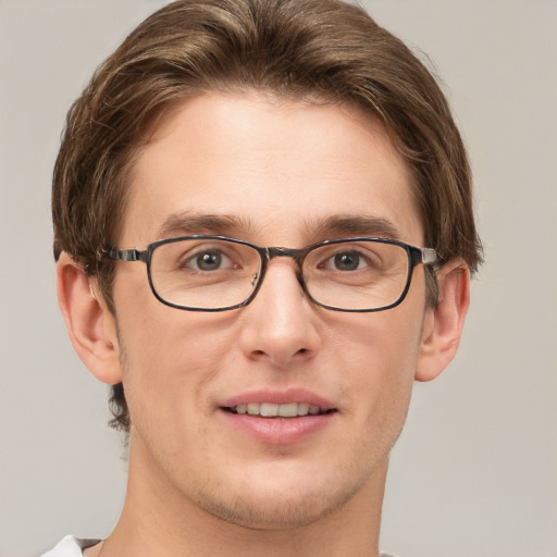 Joyful white adult male with short  brown hair and grey eyes