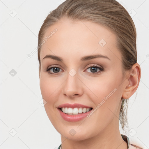 Joyful white young-adult female with long  brown hair and blue eyes