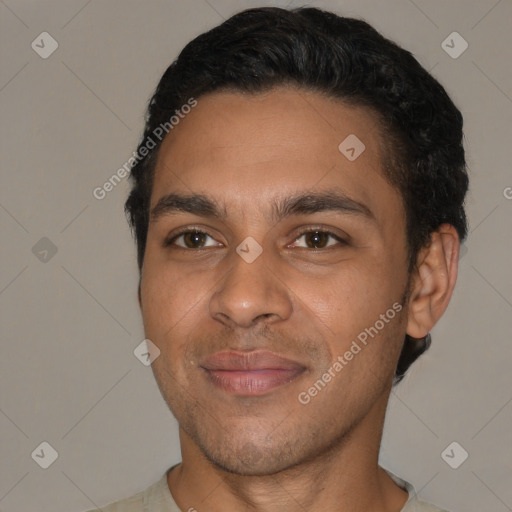 Joyful latino young-adult male with short  black hair and brown eyes