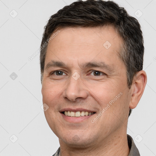 Joyful white adult male with short  brown hair and brown eyes