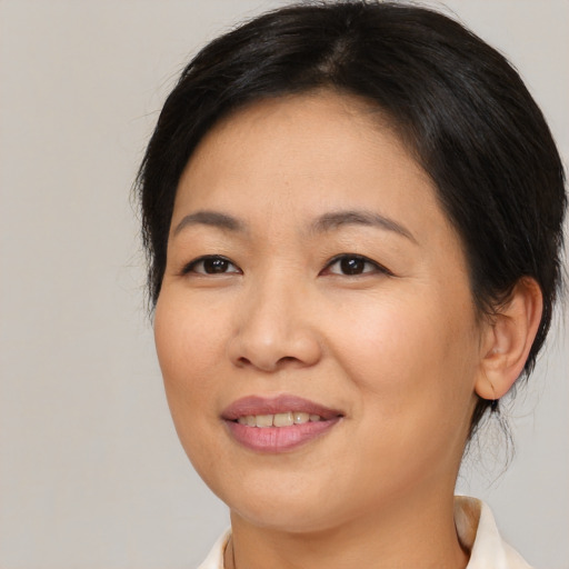Joyful asian young-adult female with medium  brown hair and brown eyes