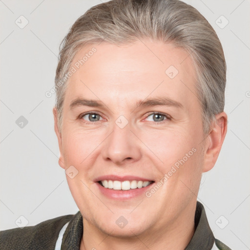 Joyful white adult male with short  brown hair and brown eyes