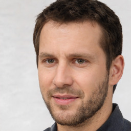 Joyful white adult male with short  brown hair and brown eyes