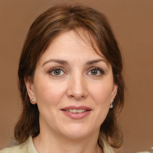 Joyful white young-adult female with medium  brown hair and grey eyes