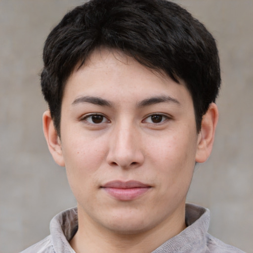 Joyful asian young-adult male with short  brown hair and brown eyes