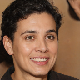 Joyful white young-adult male with medium  brown hair and brown eyes