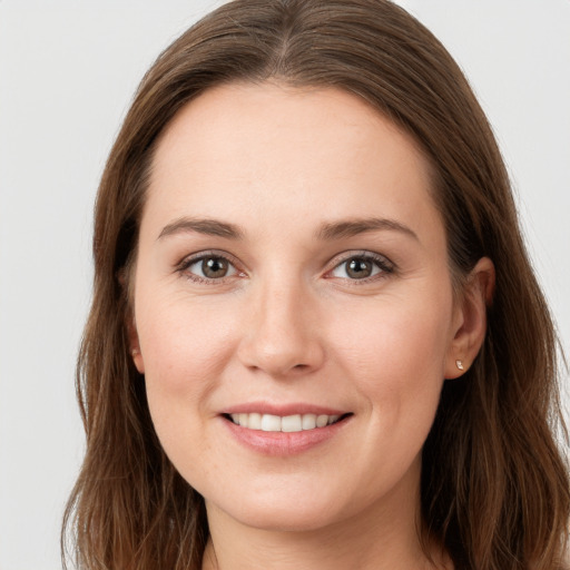 Joyful white young-adult female with long  brown hair and grey eyes